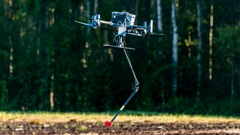Drone flying over a mining site during a geophysical survey for mineral exploration