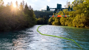 Drone equipped with ground-penetrating radar flying over a snow-covered glacier