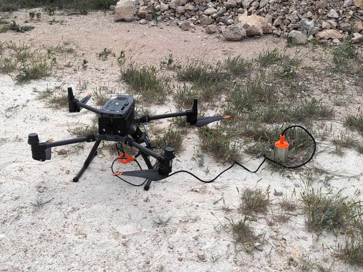 Image of UAV on the ground with echo sounder payload during bathymetry survey at Texas quarry, May 2025