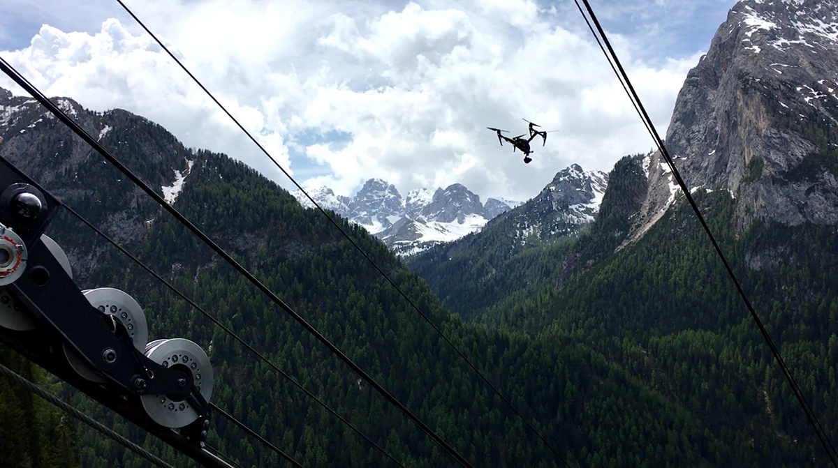 Drone inspecting aerial marker cables of a mountain cable car system, part of Ileron’s UAV inspection project