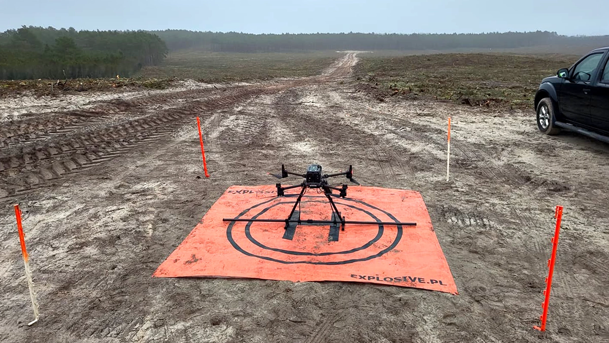 DJI Matrice 350 RTK with SENSYS MagDrone R4 magnetometer on Explosive.pl landing pad at a cleared coastal UXO survey site in northern Poland