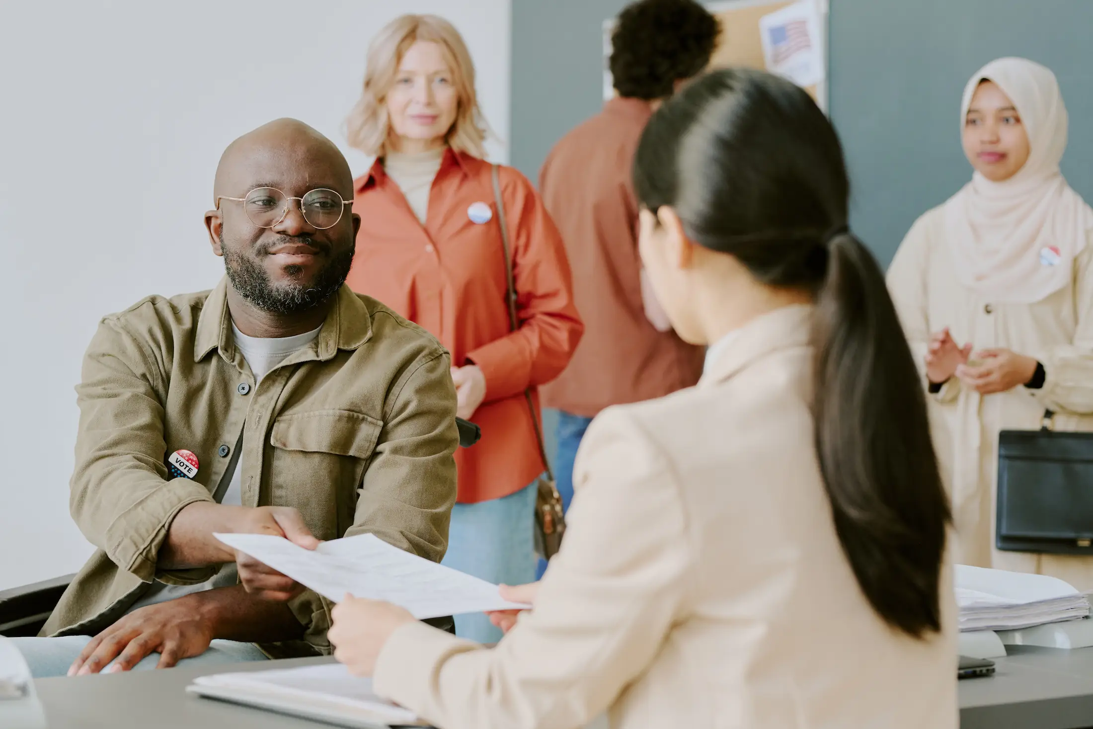 man handing resume to interviewee