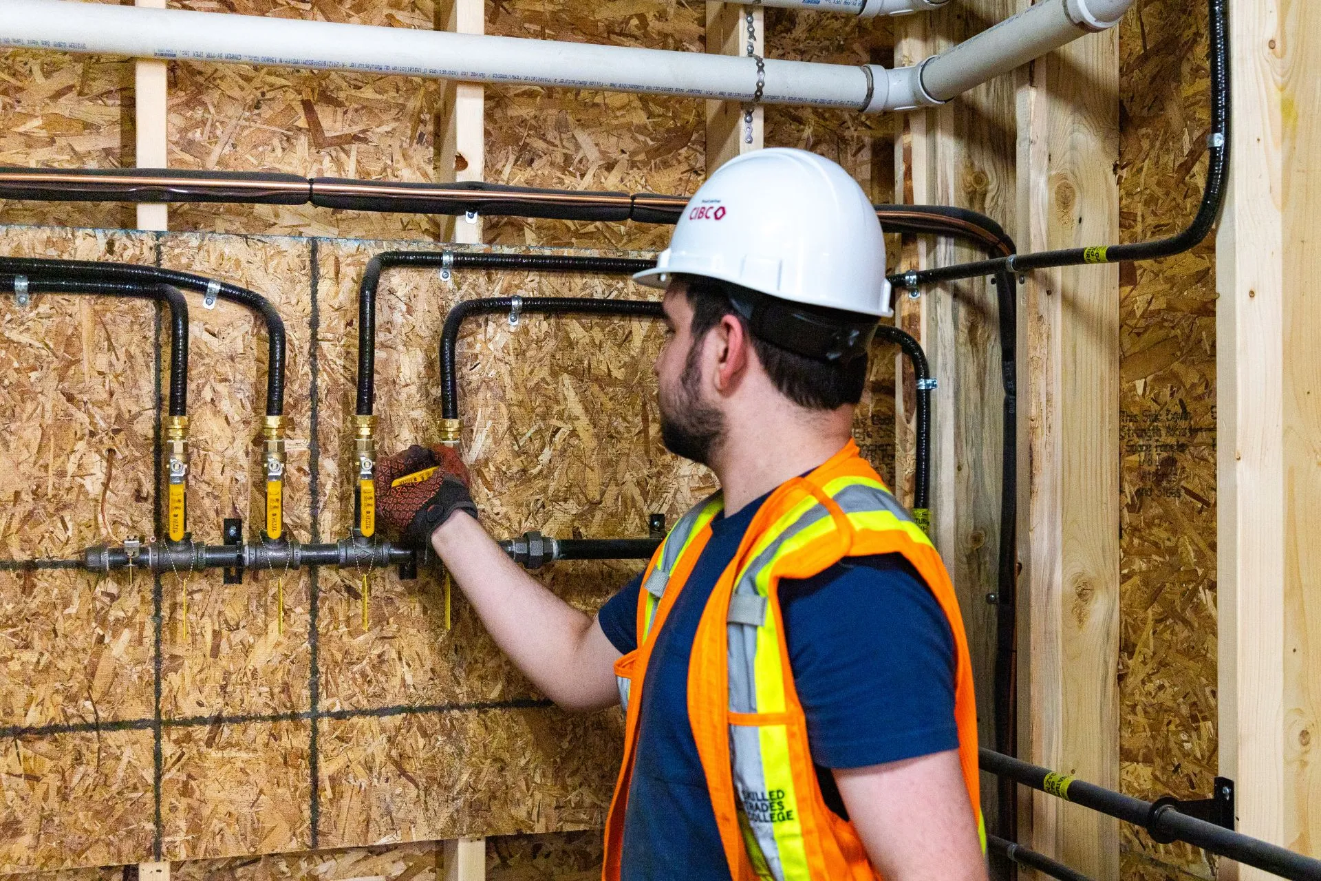 Tradesperson checking the pipes of a plumbing system