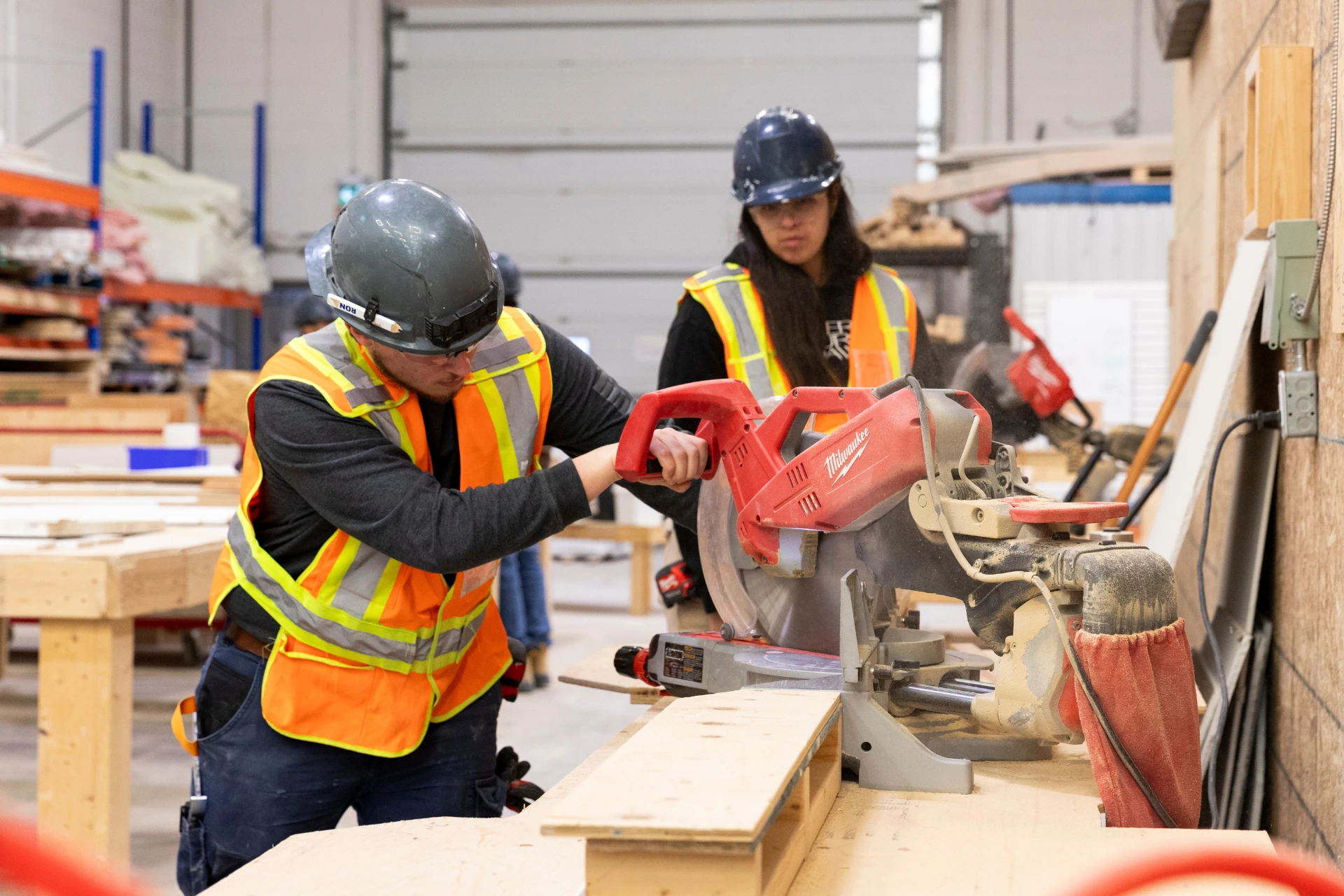 Two Skilled Trades College of Canada Students work with a circular saw