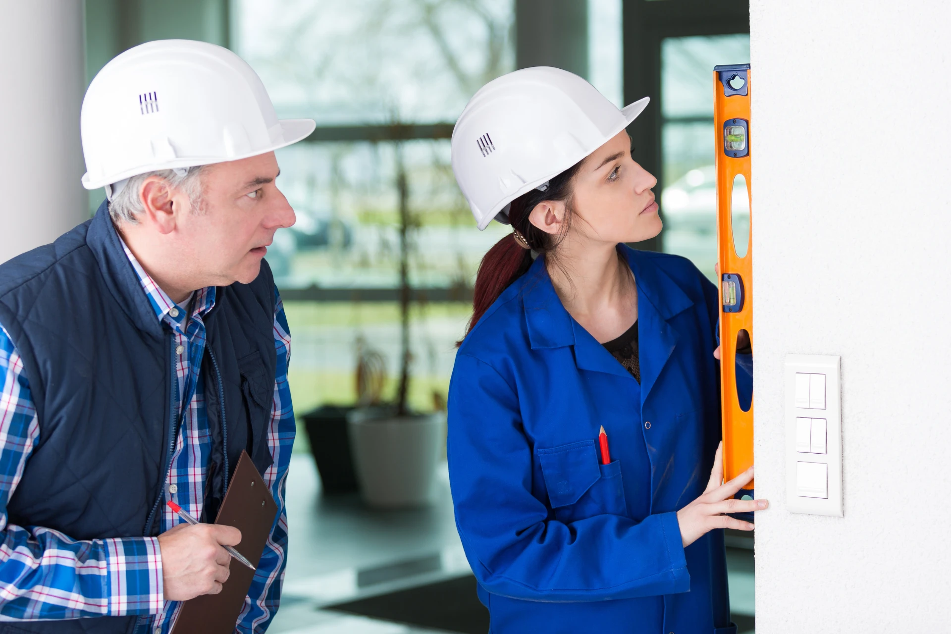 An aspiring journeyperson learning from a skilled worker