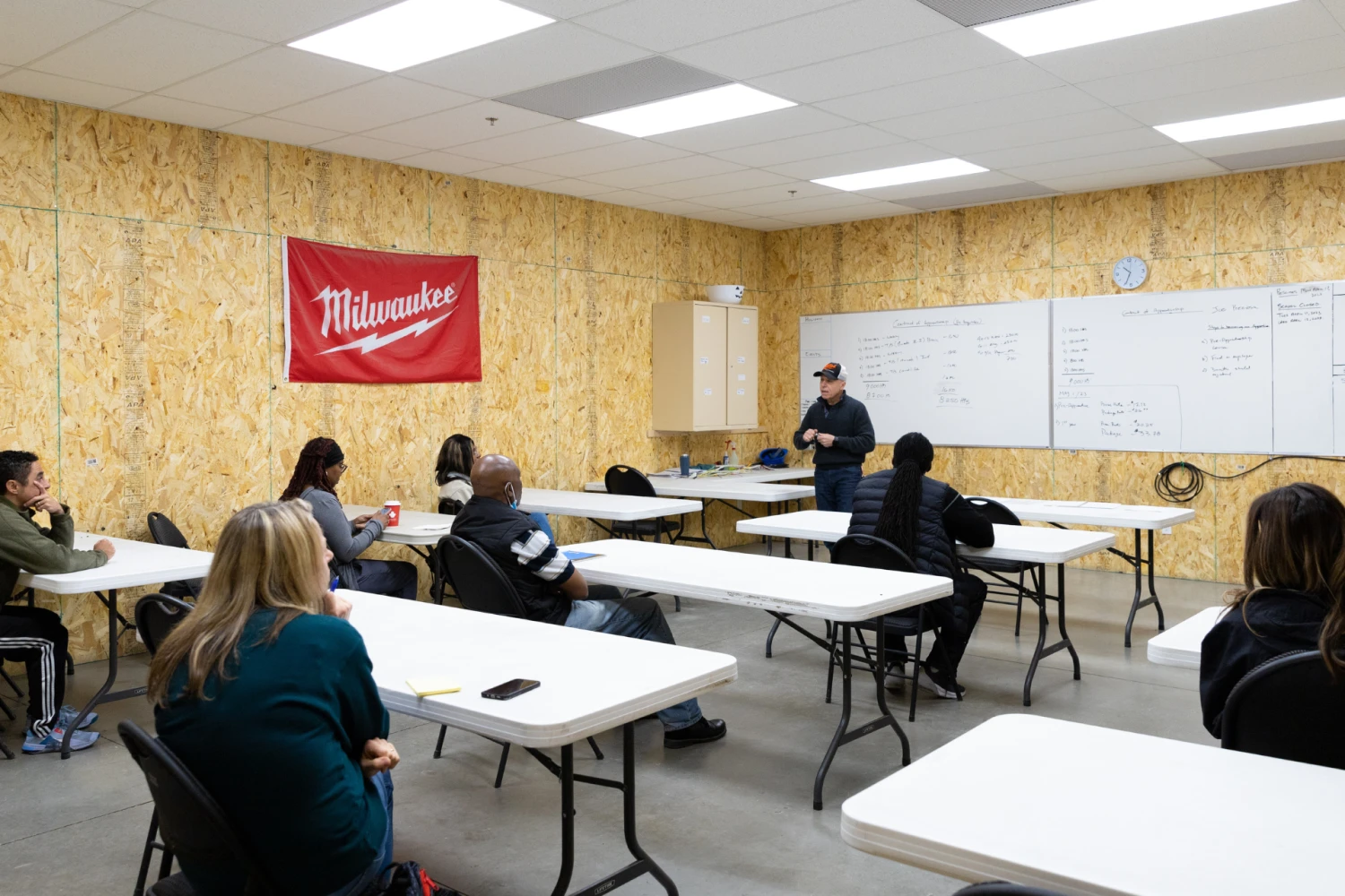 Pre-apprenticeship students from Skilled Trades College of Canada listening to an instructor in a classroom