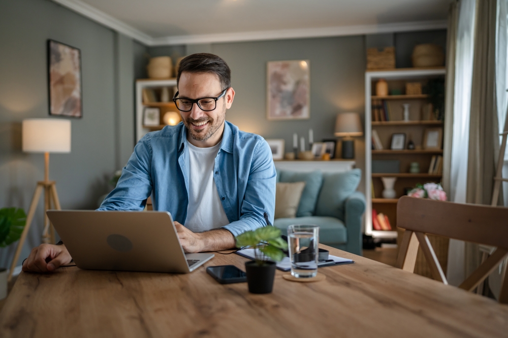 Man smiling while nominating a neighbor online for a Go Local gift bundle.