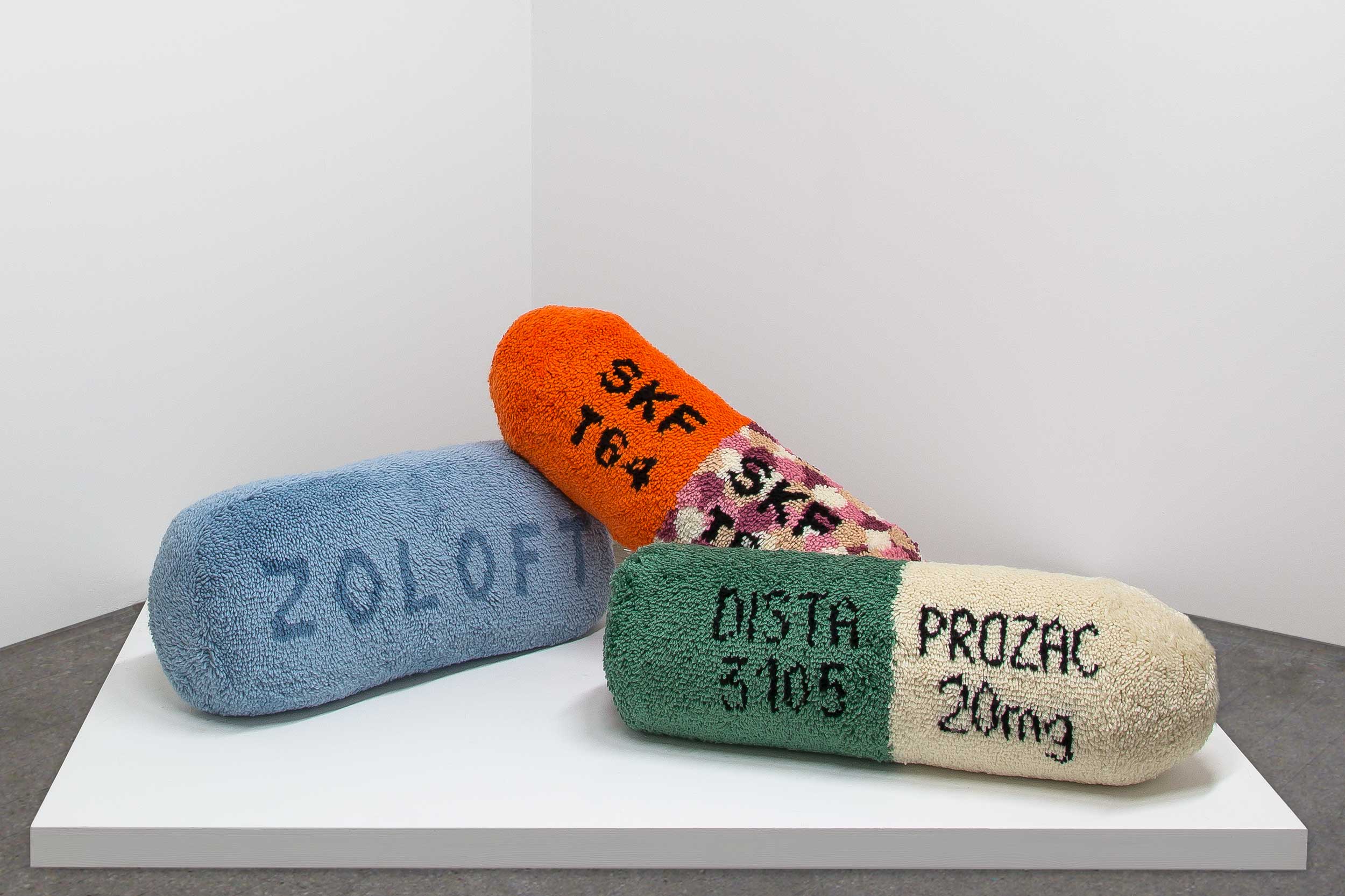 hand latch hooked soft sculptures of oversized antipsychotic and antidepressant pills