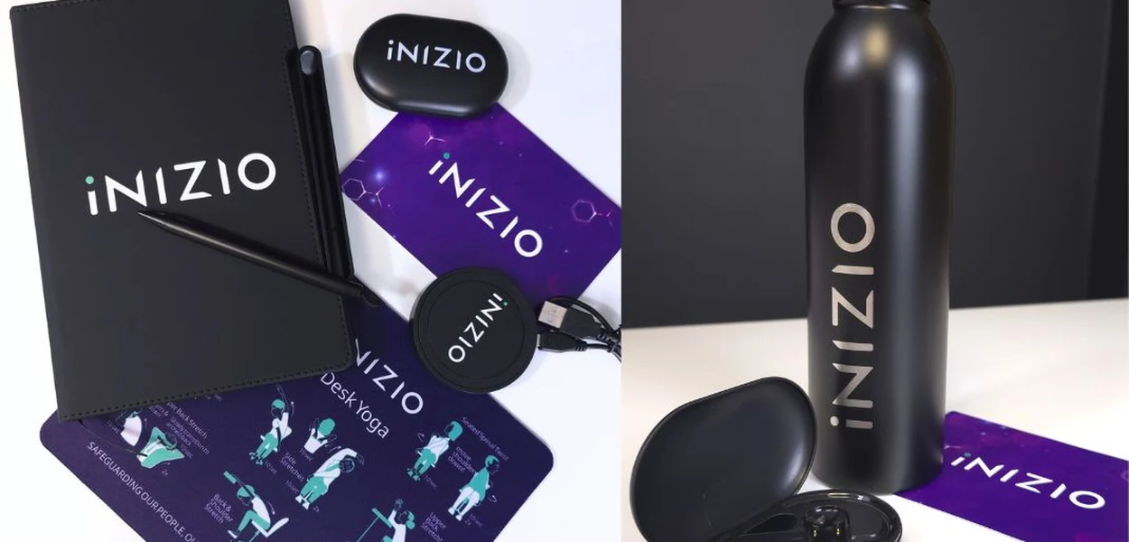 Inizio pack items: notebook, mouse mat, earbuds, charger and bottle