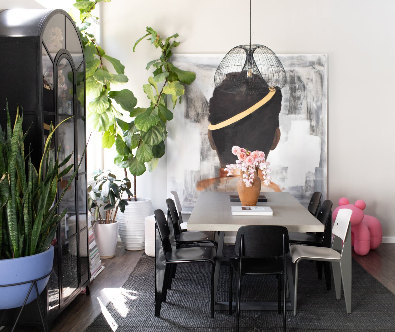 dining room with greenery and large scale art