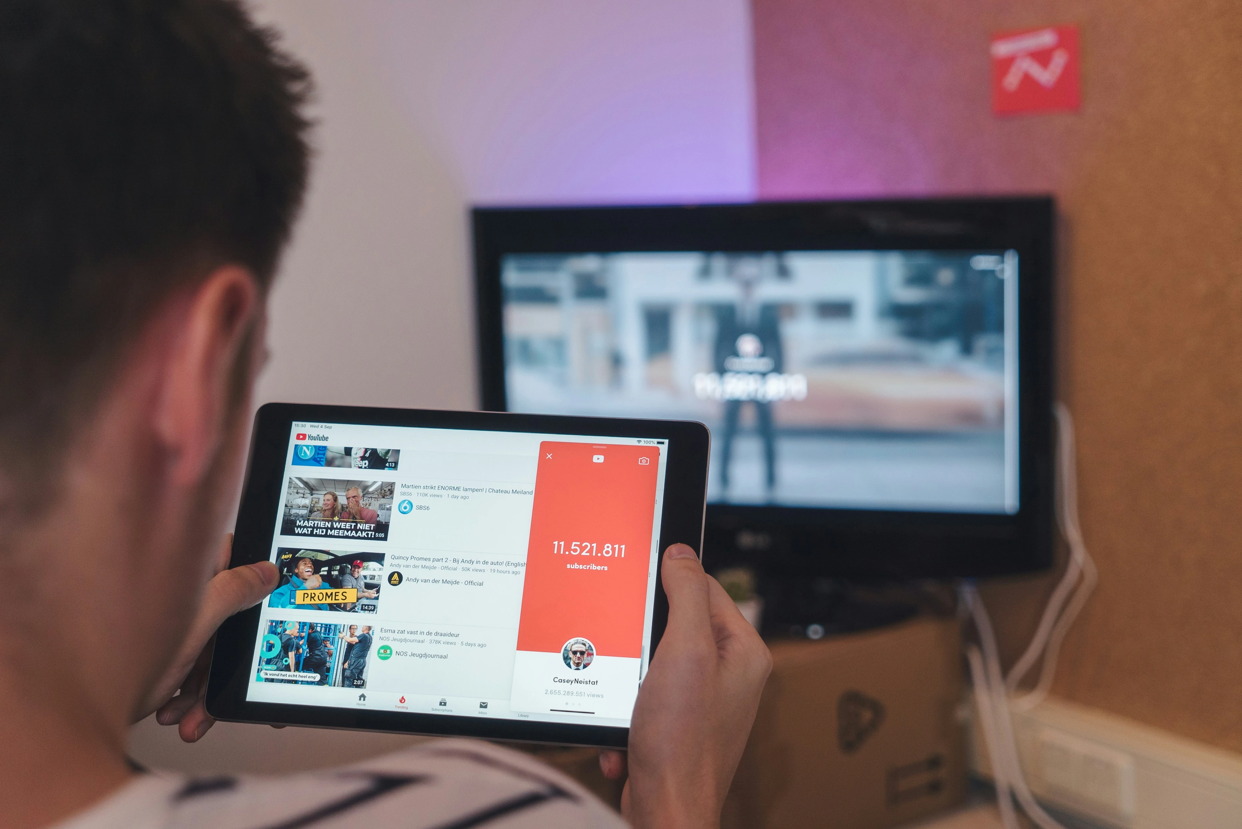 Teen holding his tablet whilewatching youtube