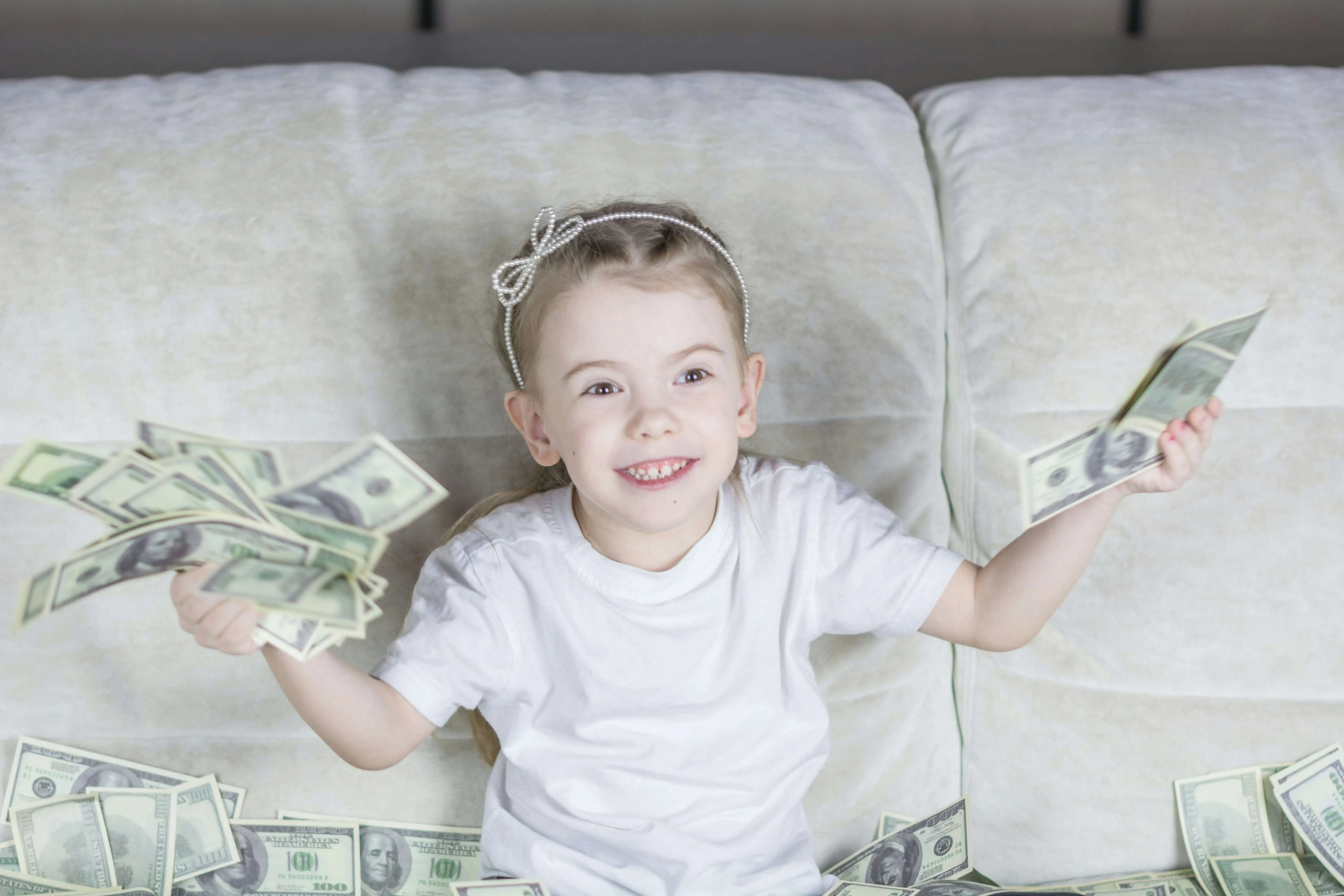 Little girl holds cash