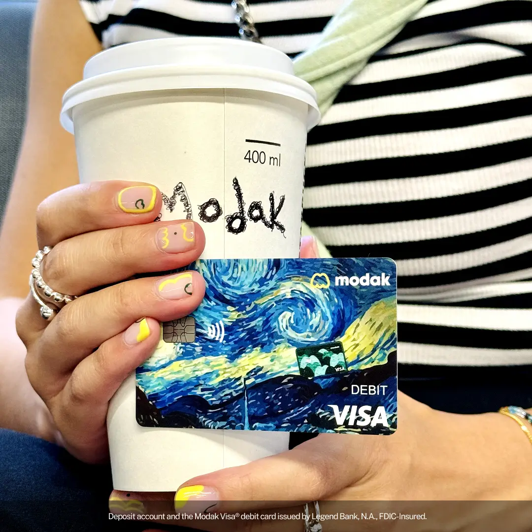 Modak Visa debit card and starbucks cup