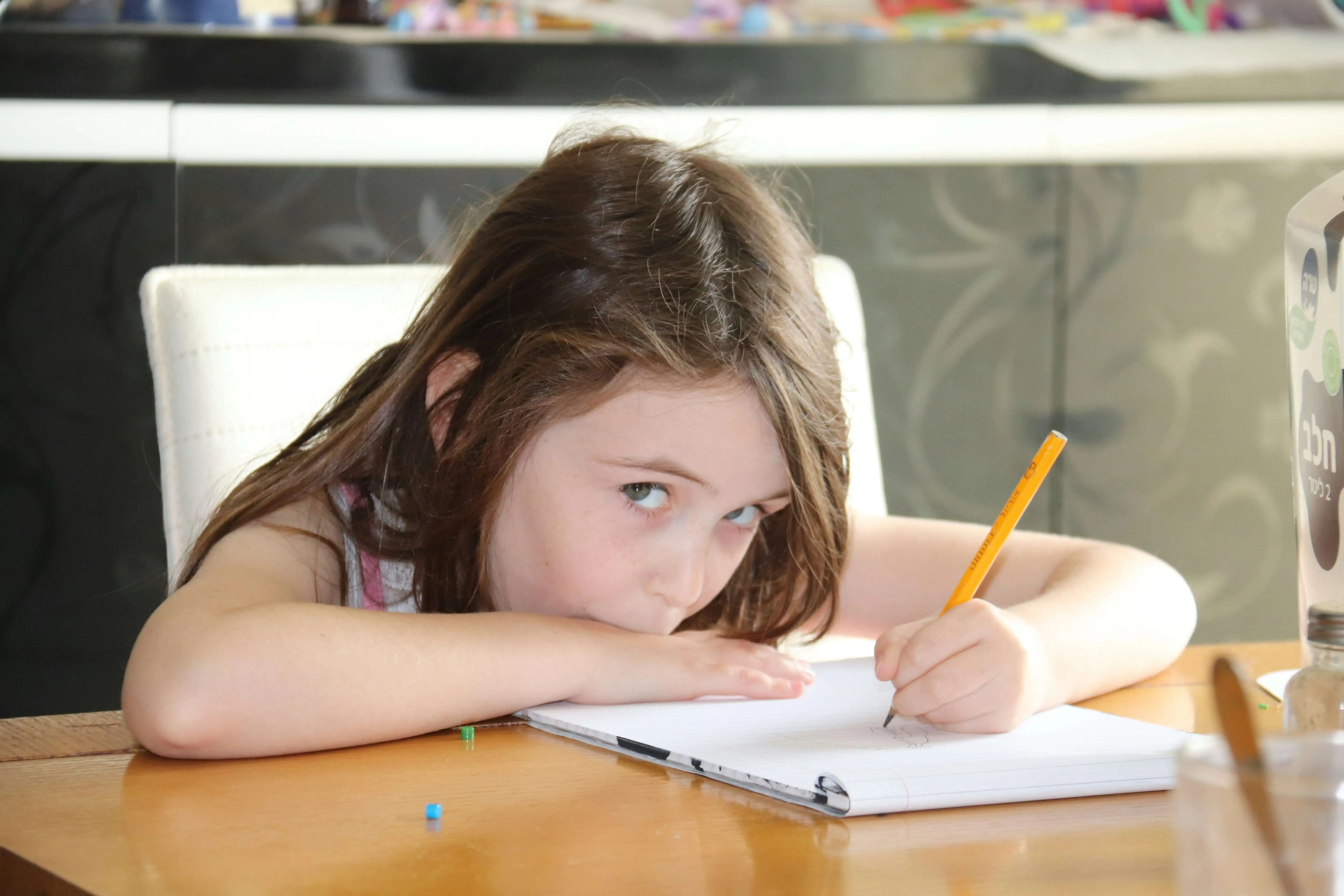 Girl writing and thinking 