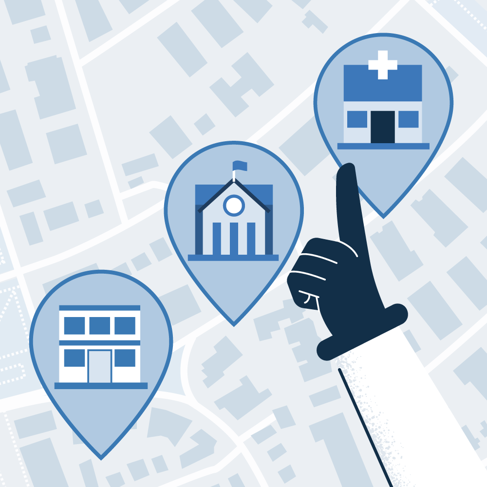 An illustration of a hand pointing at three large location pins on a map. The pins contain icons for a generic office building, a school or government building, and a hospital, symbolizing the definition of secure or important geographical zones for automated vigilance.