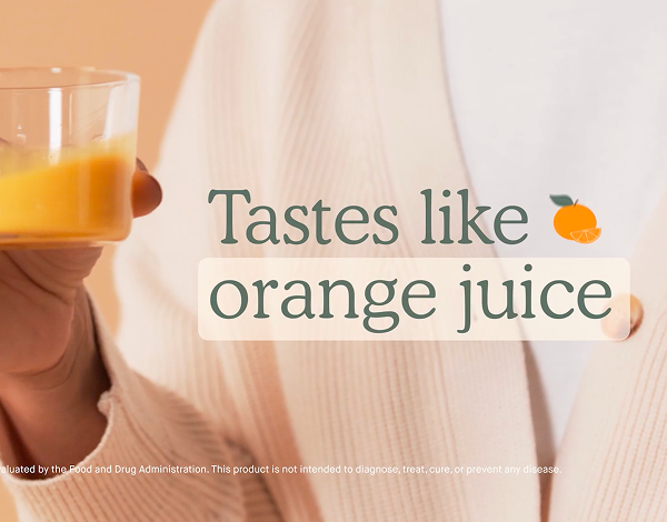Person holding a glass of orange juice with text overlay reading 'Tastes like orange juice' and a small orange graphic.