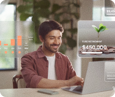 Smiling man using a laptop with transparent financial graphs showing a $450,000 FI/RE retirement goal.