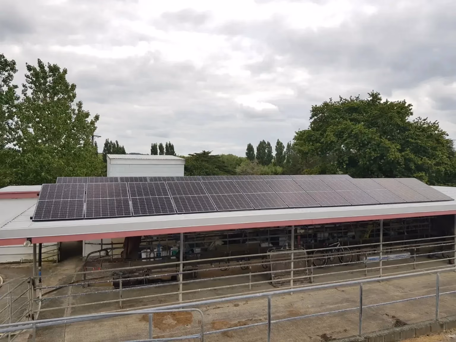 Solar panels on the roof of a farm and a Redback Hybrid Battery & Inverter in Northland.