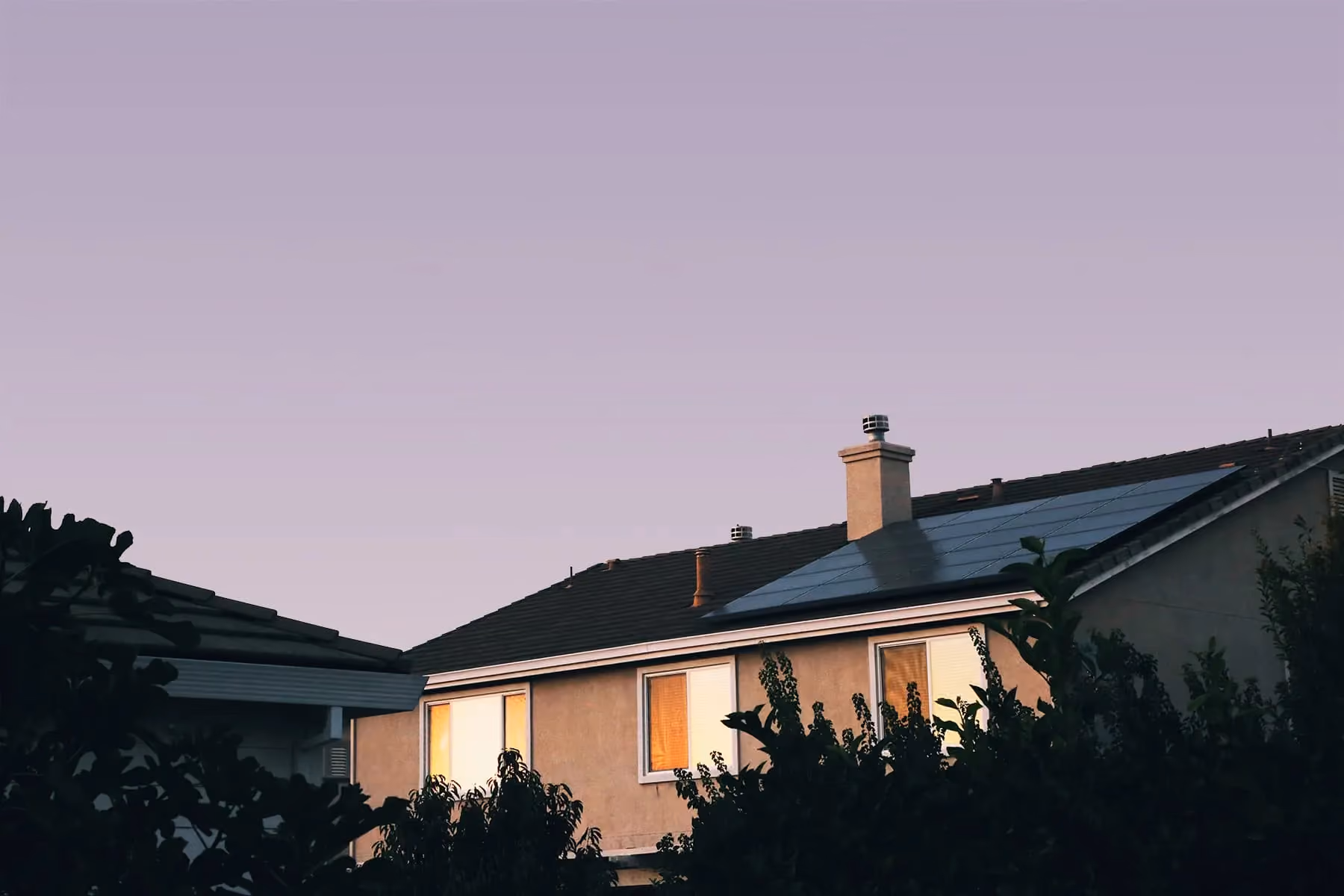 Solar panels on a house at dusk.