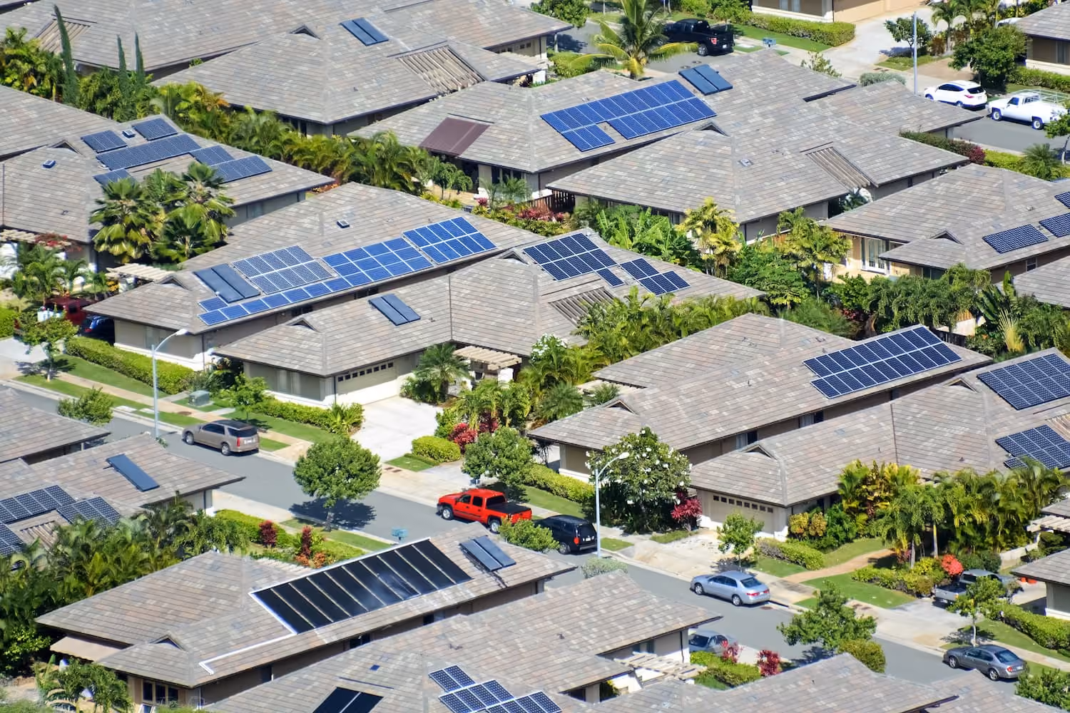 An aerial view of a residential neighborhood with solar panels.