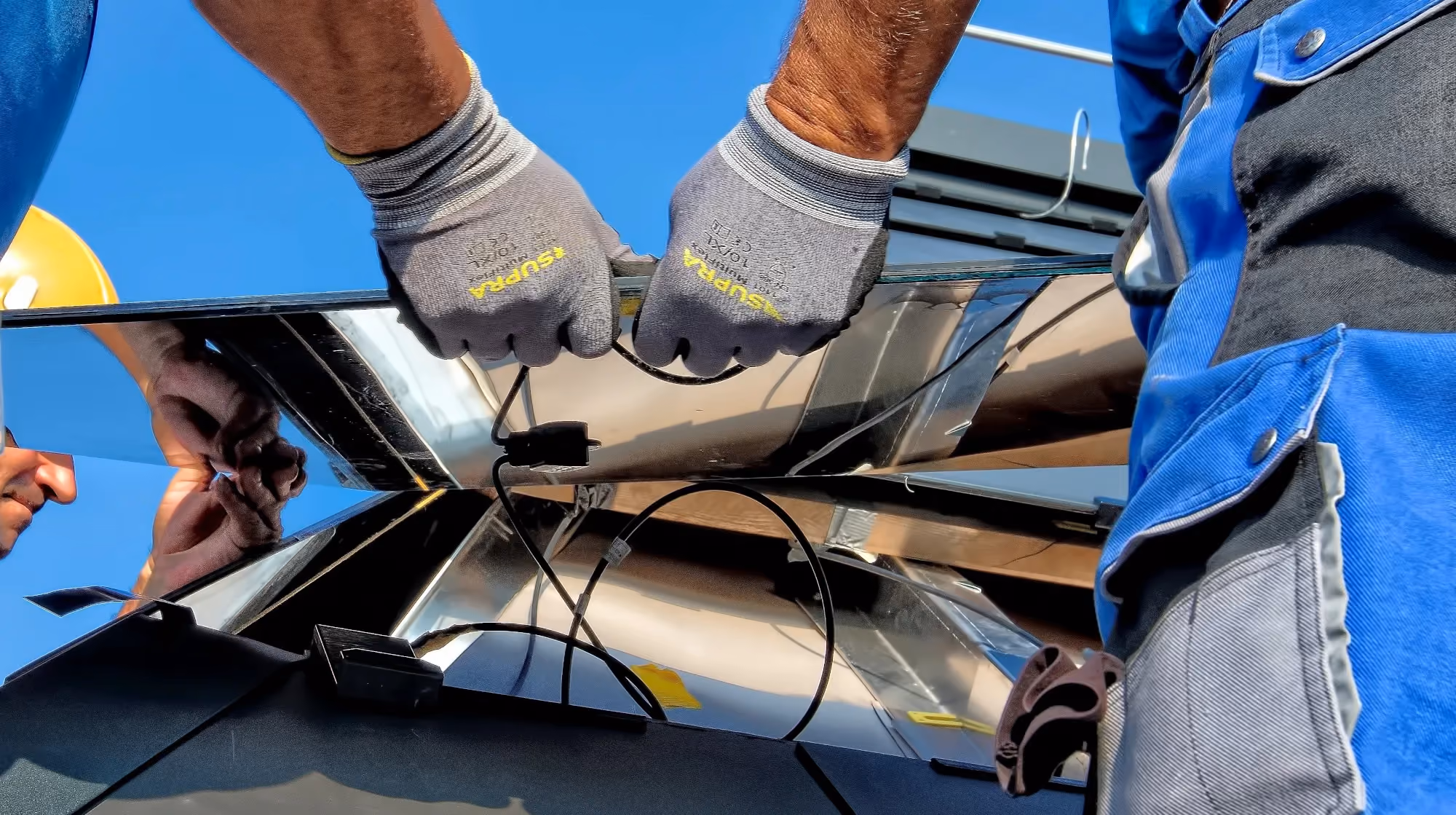 Two men working on a solar panel.