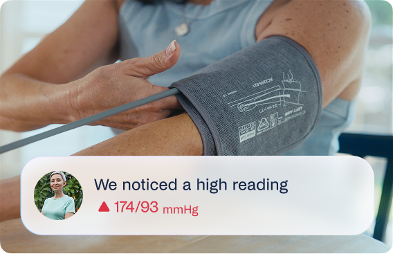 A woman taking her blood pressure with a message from her Care Team