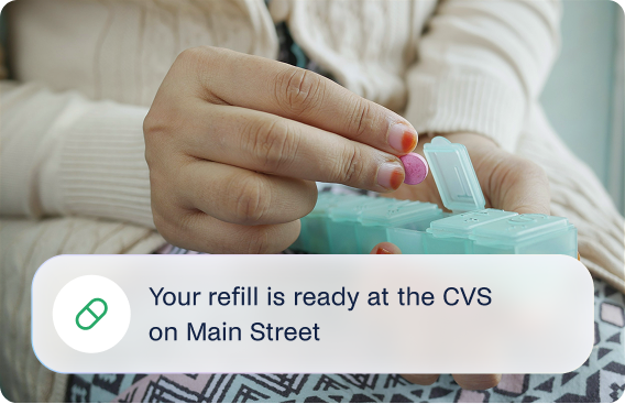 A woman taking medications with a message explaining that her new refill is ready