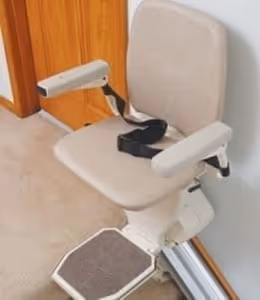 SL600 stair lift with ergonomic padded seat, foldable footrest, and safety armrests installed on indoor staircase for reliable home mobility assistance.