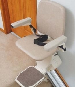 SL600 stair lift with ergonomic padded seat, foldable footrest, and safety armrests installed on indoor staircase for reliable home mobility assistance.
