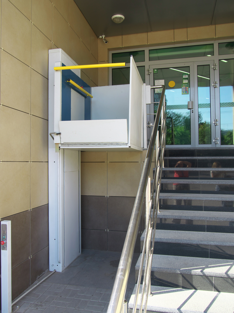 Wheelchair lift installed on outdoor staircase for improved accessibility and mobility support.
