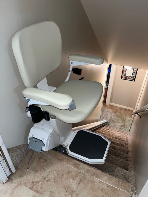 Indoor stairlift installed on residential staircase, providing safe and reliable mobility assistance for seniors and individuals with disabilities.