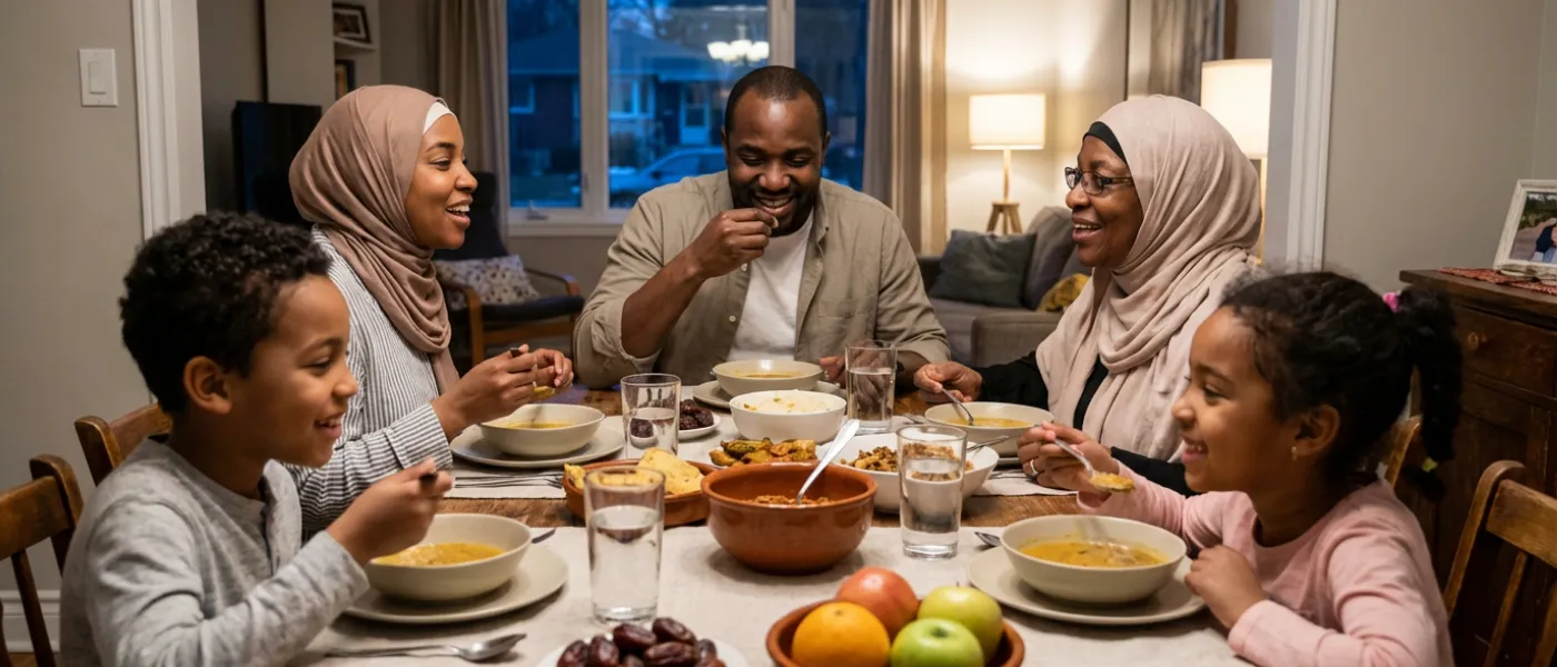 A family of five enjoys a warm, cozy dinner at home. They share smiles around a table with soup, fruit, and bread, conveying joy and togetherness.