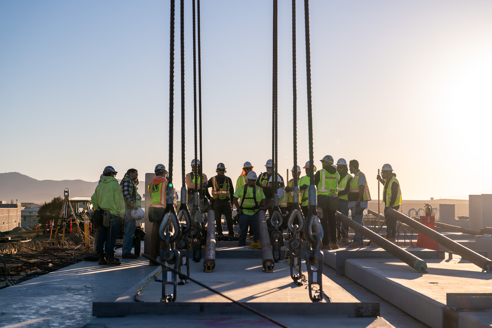An Oltmans employee on a construction site at sundown