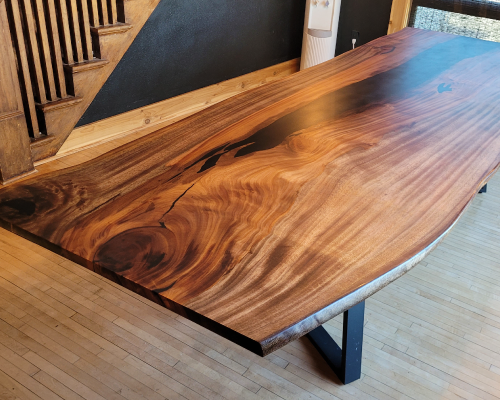 Wild cashew dining table with black epoxy river. 