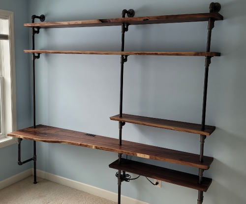 Walnut desk with pipe shelving.