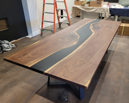 Walnut black epoxy river table.