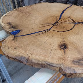 Wood round table with blue epoxy highlights. 