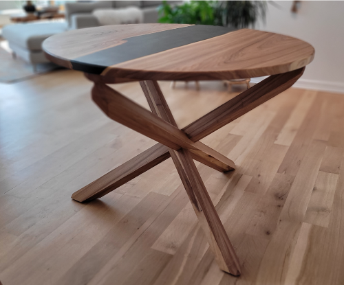 Elm round table with black epoxy river and half lap legs. 