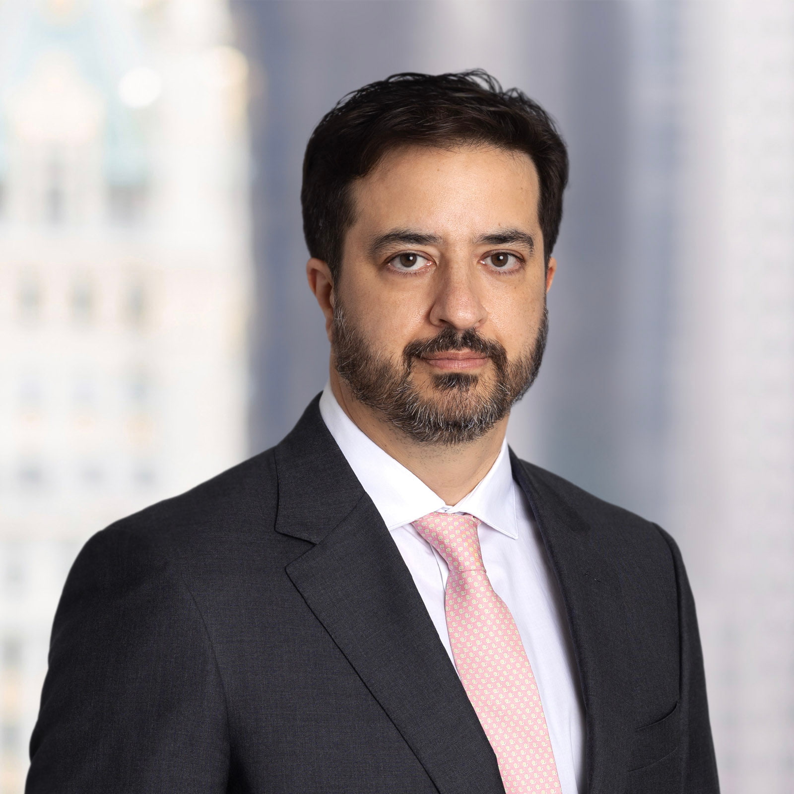 Ed Keyl headshot in front of blurred NYC office window.