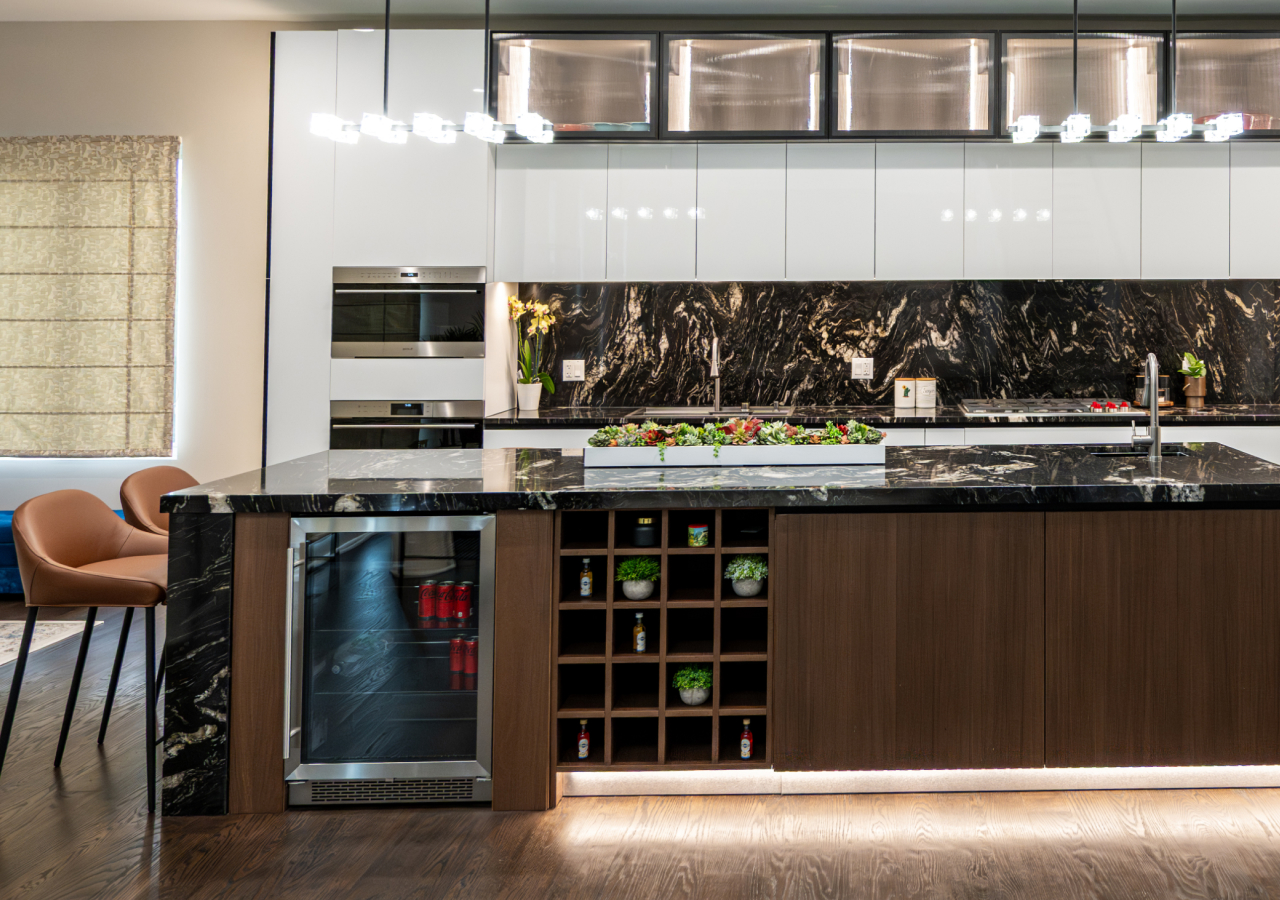 Contemporary kitchen with black marble island, wood accents, built-in wine storage, and sleek lighting.