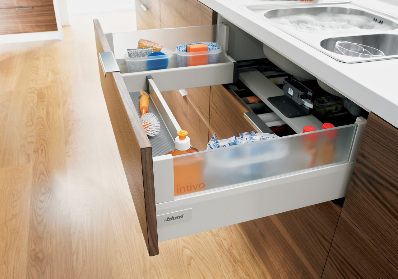 A sink drawer full of cleaning supplies