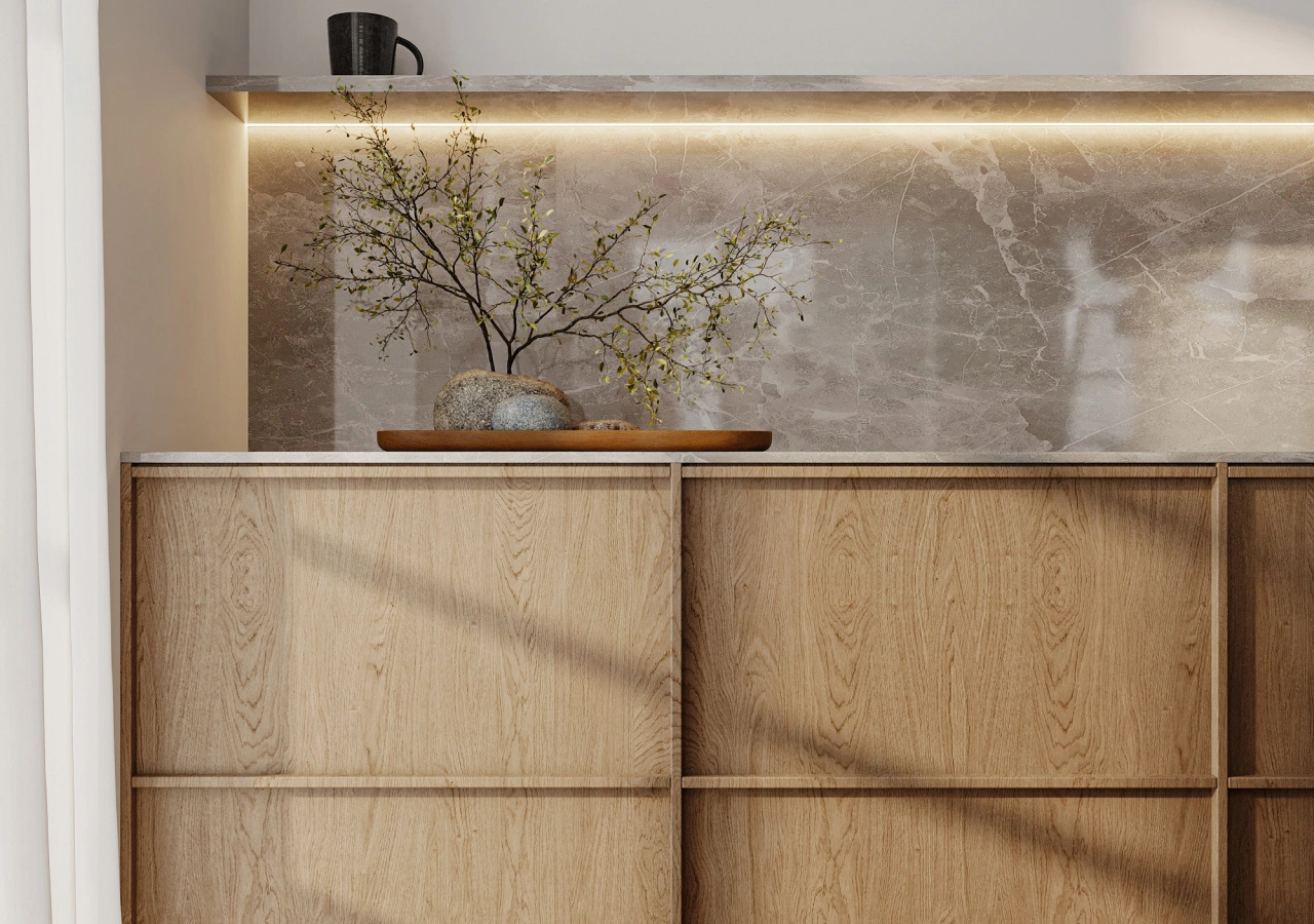 Oak frame-and-panel cabinets with a lit stone backsplash