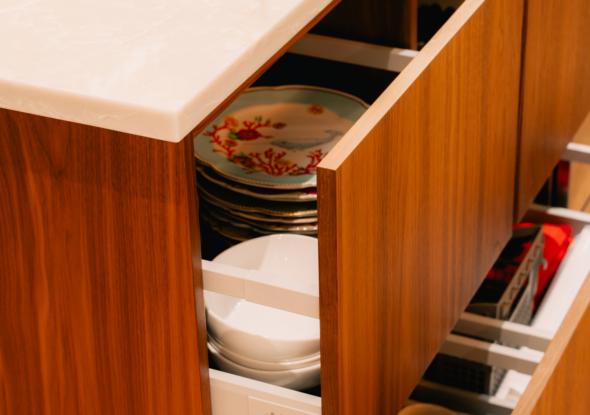 Walnut drawer open with plates in a holder