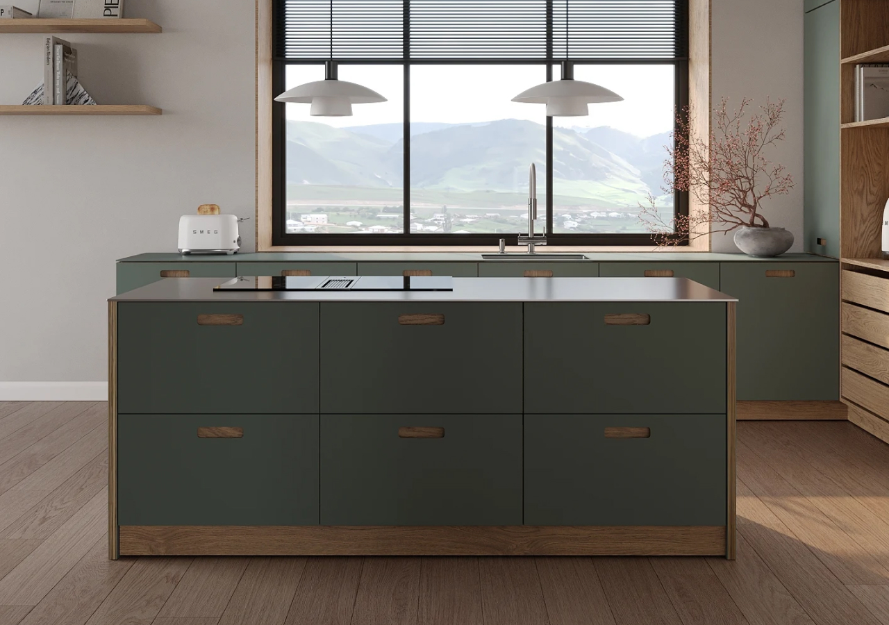 Dark green island with a stone top in front of a wide window