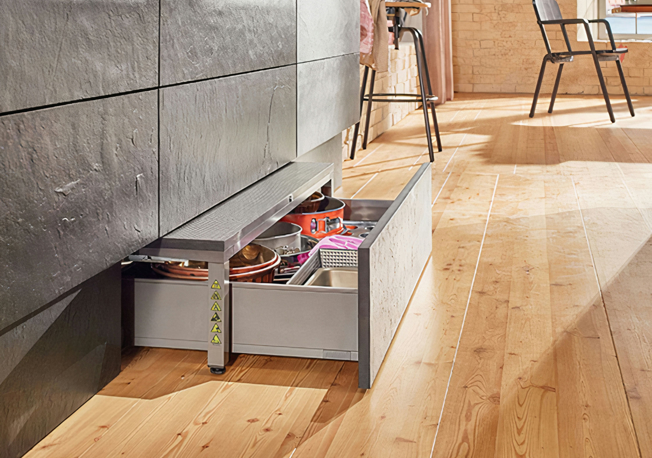 Toe-kick drawer pulled out under oak cabinets