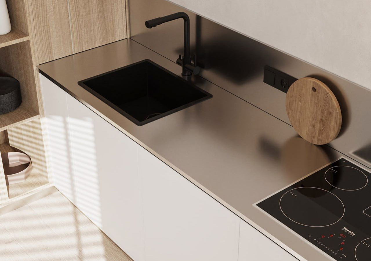 Stainless steel countertop with a black sink and a cooktop
