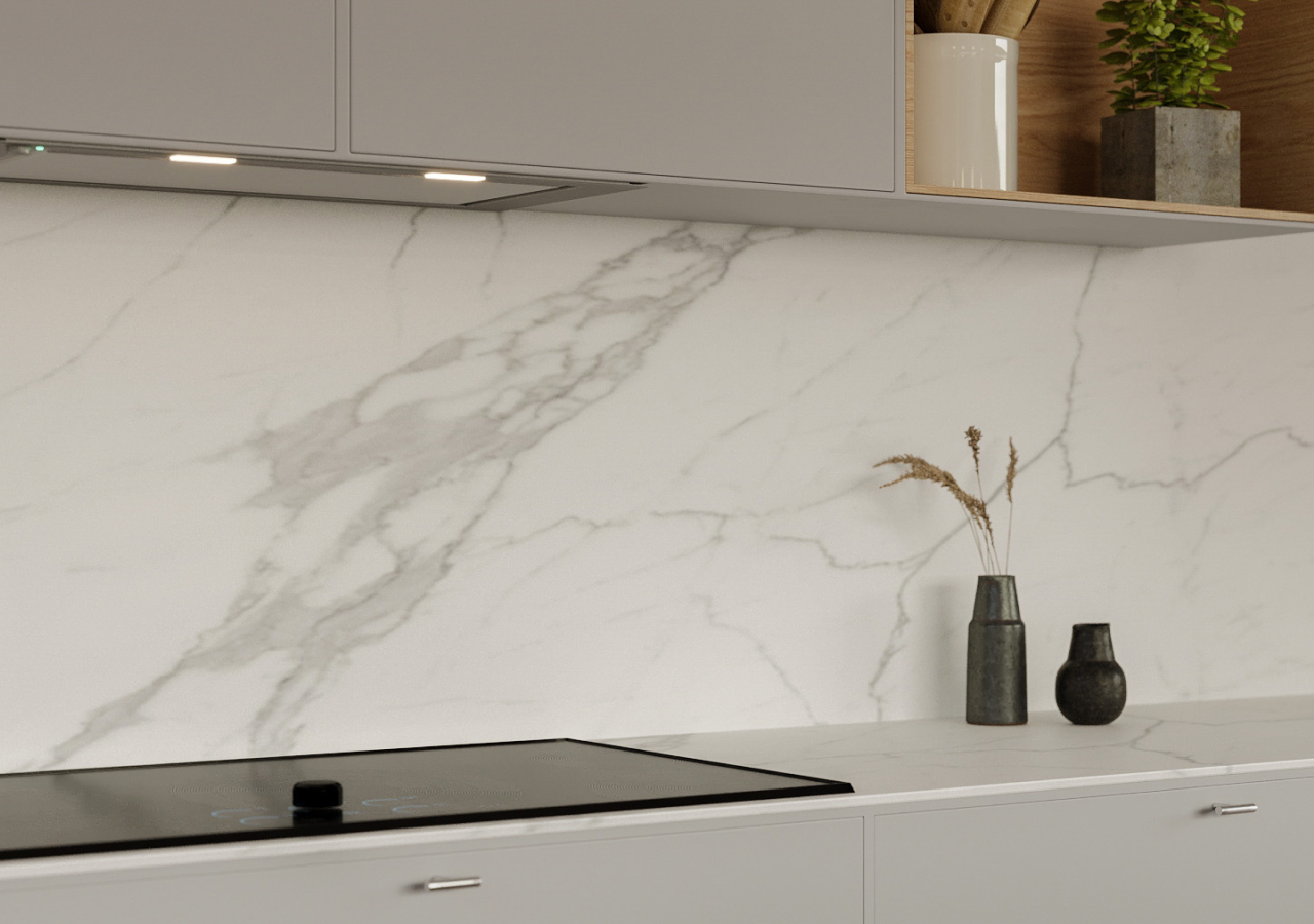 Matching marble countertop and backsplash with a black cooktop
