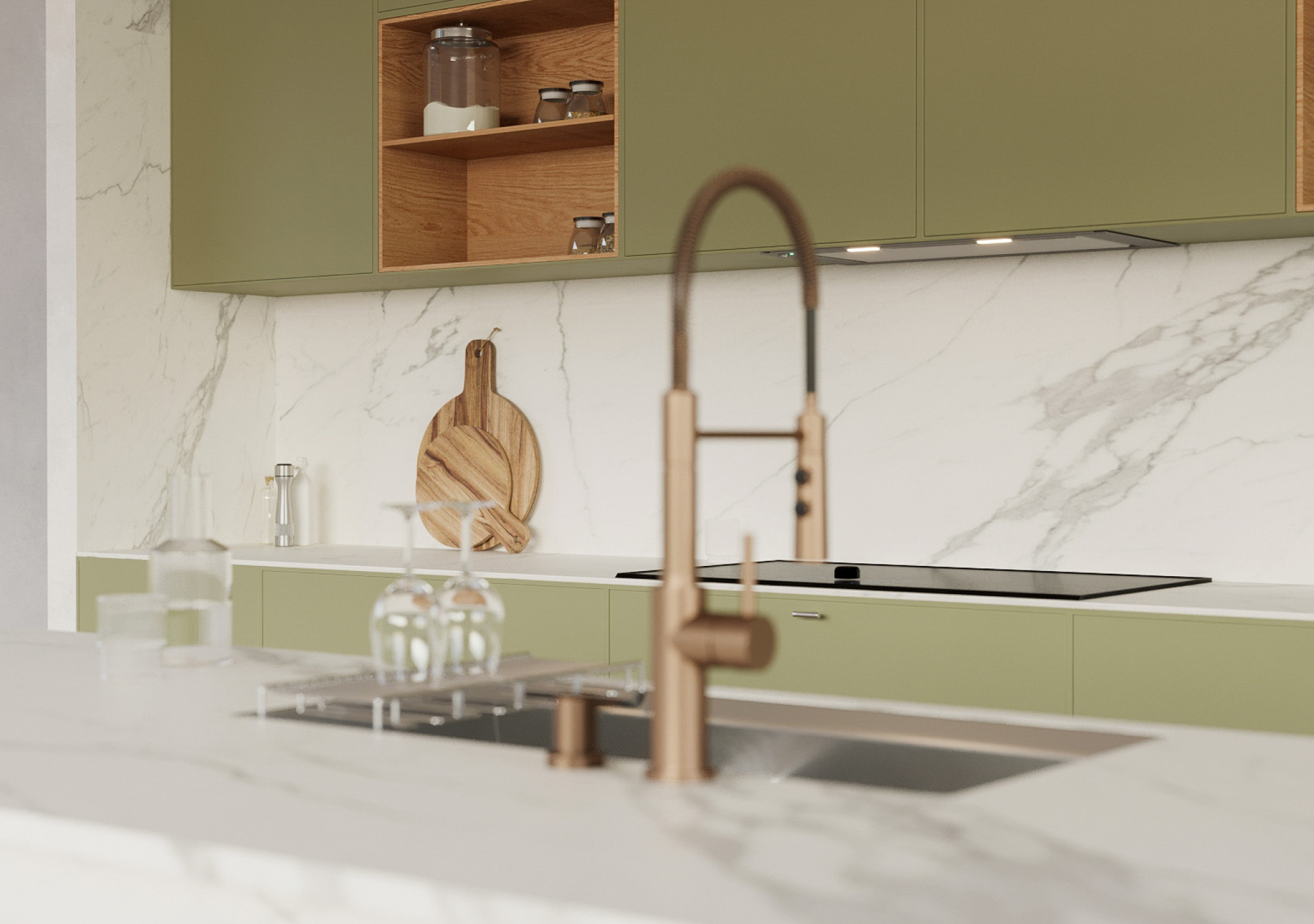 Marble backsplash with a brass faucet above a sage green cabinet