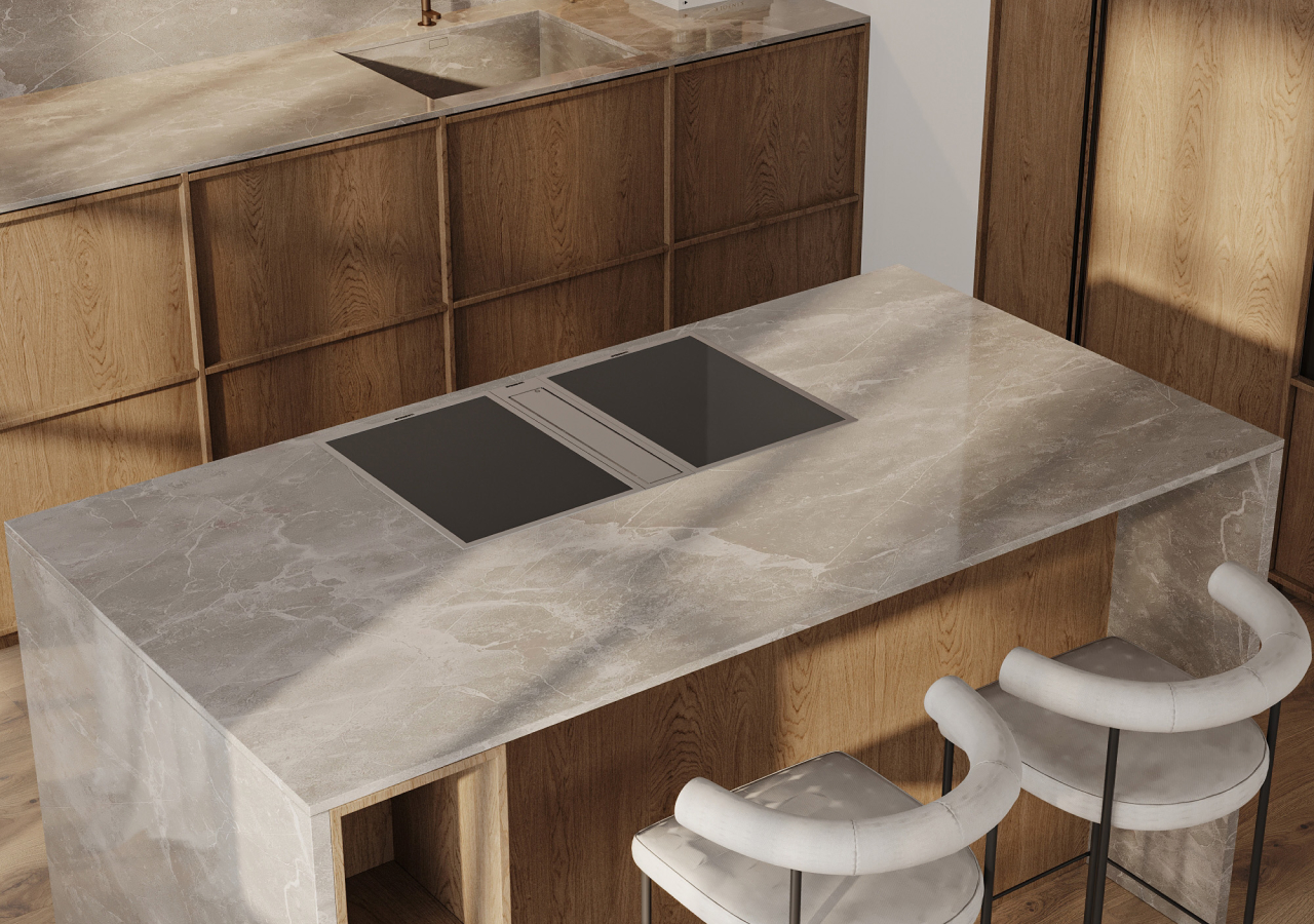 Grey stone island with a cooktop and white stools
