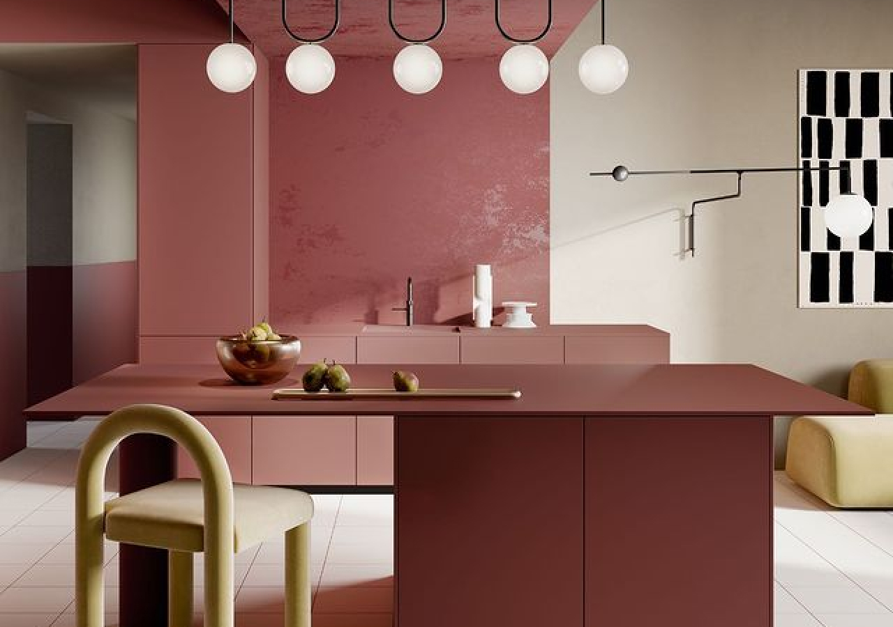 Terracotta pink kitchen with a Fenix island and a brass stool
